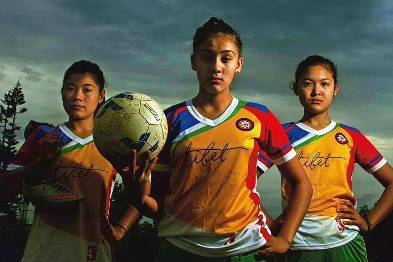 Young nuns in football kit holding a ball